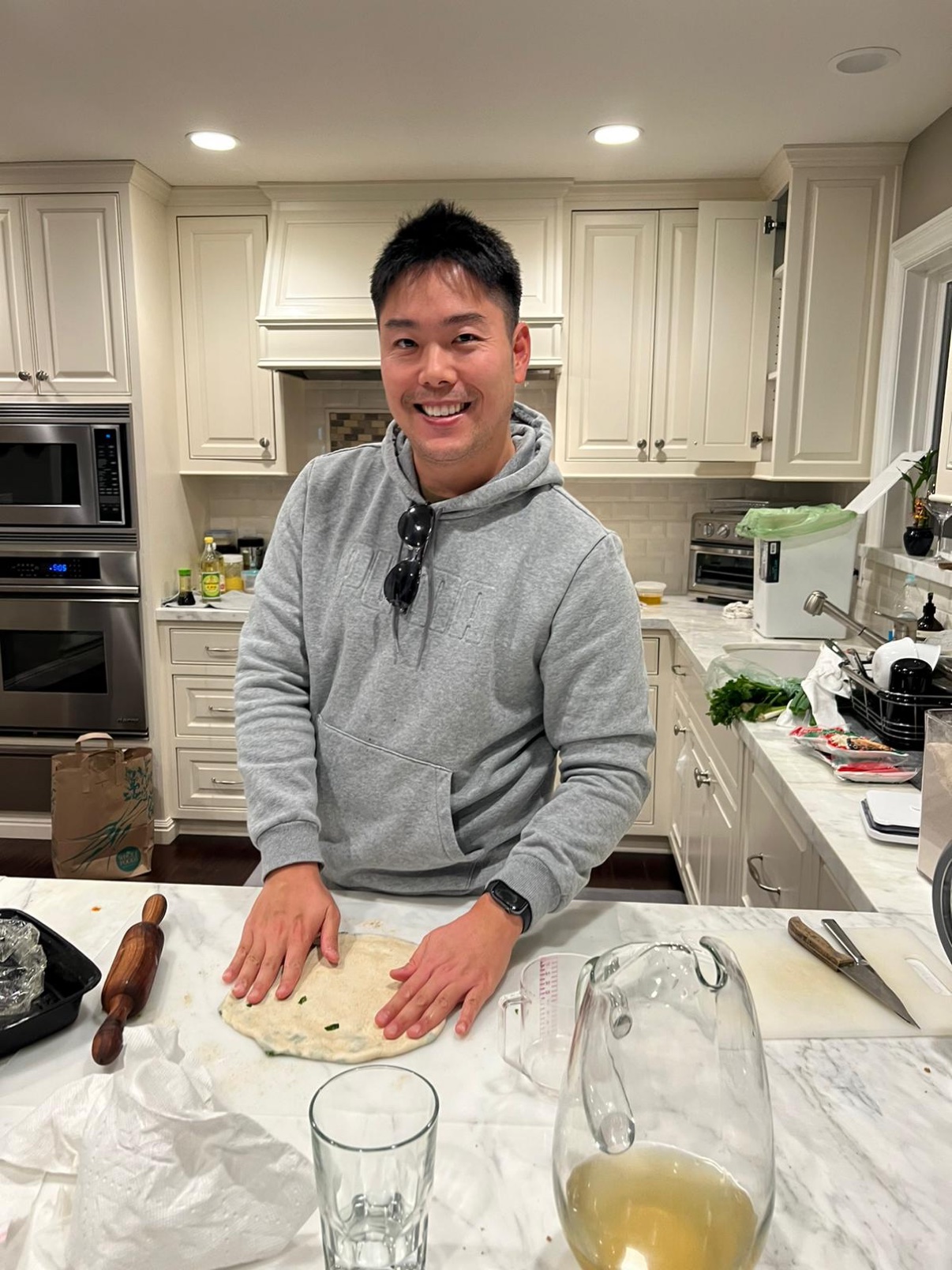 Kevin making flatbread and scallion pancakes in his kitchen