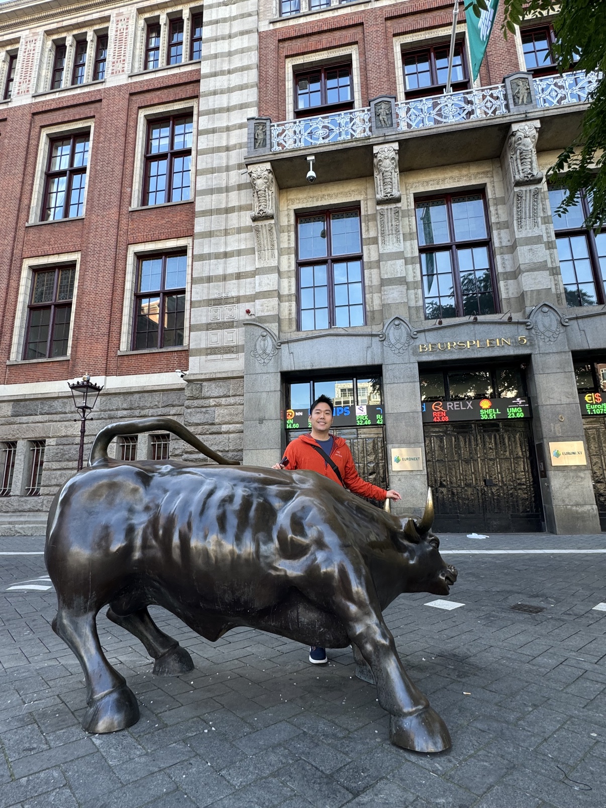 Kevin posing with the bull statue outside the Euronext Amsterdam stock exchange