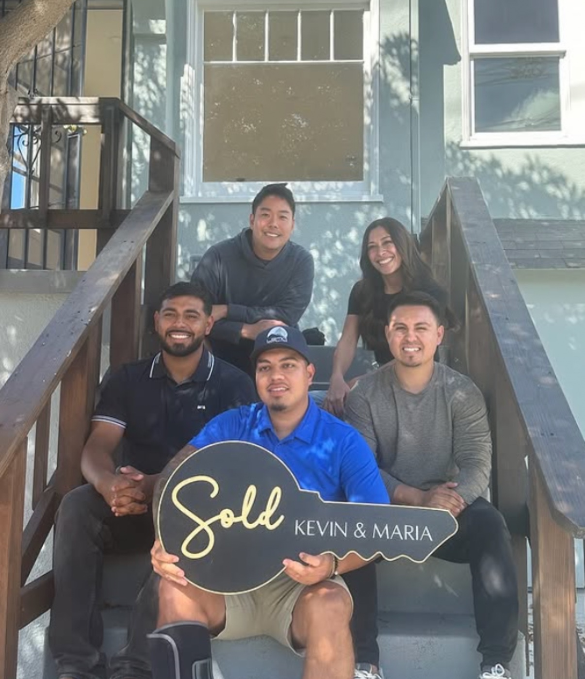 Luis M., his business partners, Kevin Liang, and Maria Rosa celebrating the sale of their renovated home