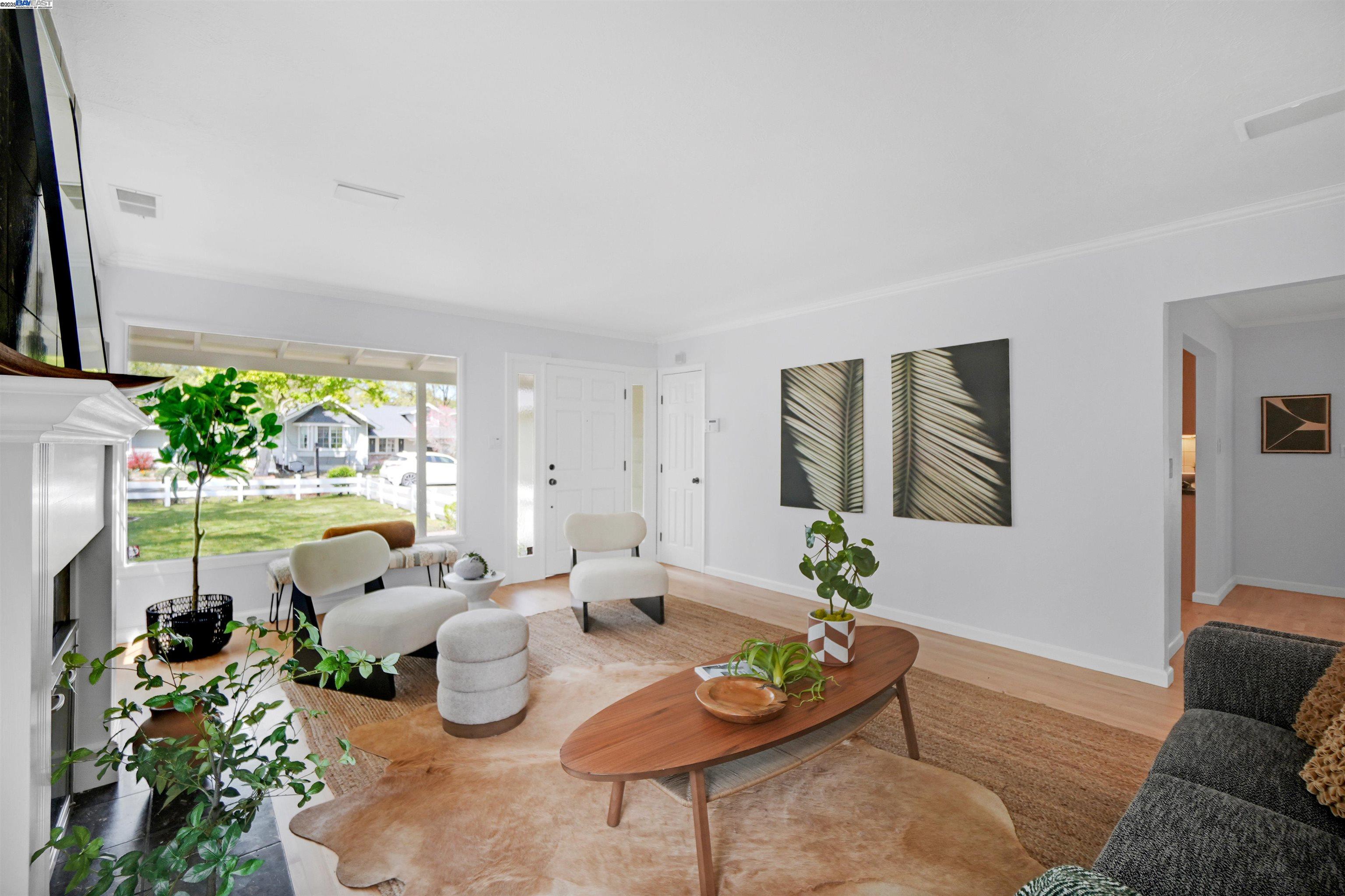 Finished Saranap living room staged around the fireplace and front windows